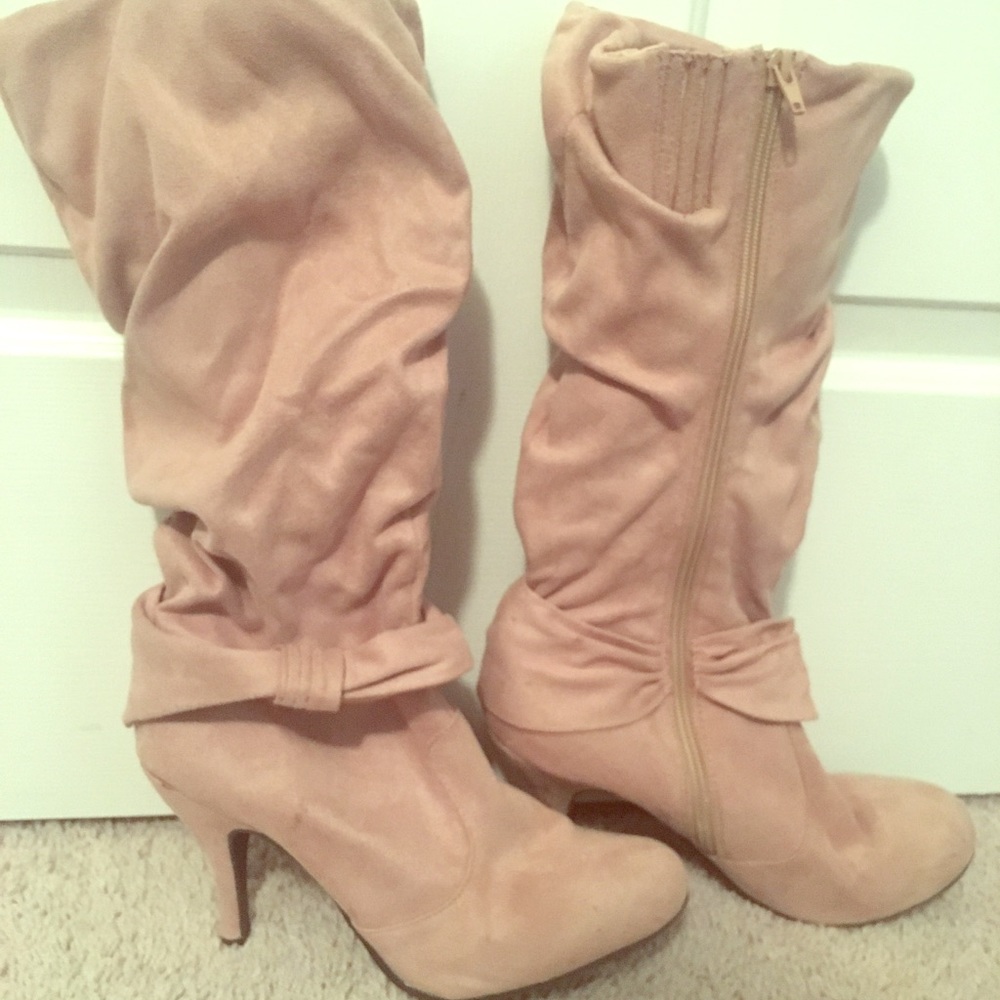 Calf high tan boots.
